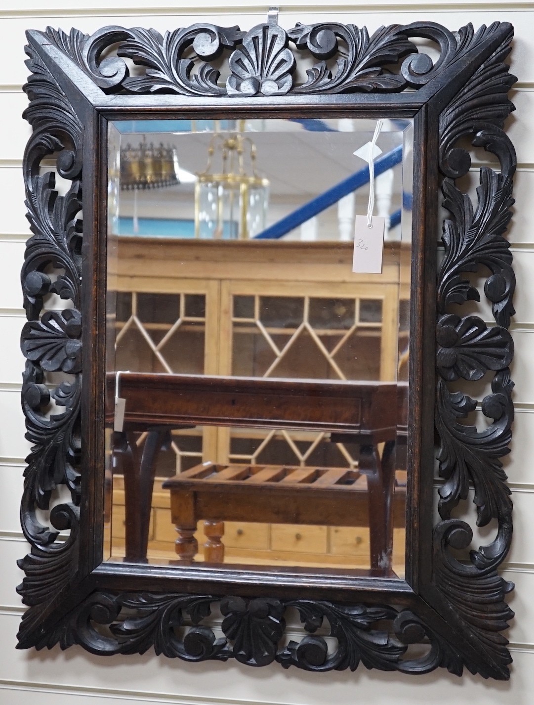 An Edwardian foliate carved oak wall mirror, width 81cm, height 64cm *Please note the sale commences at 9am.